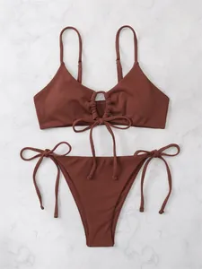 Detailed view of brown ribbed tie-front triangle bikini set on marble surface