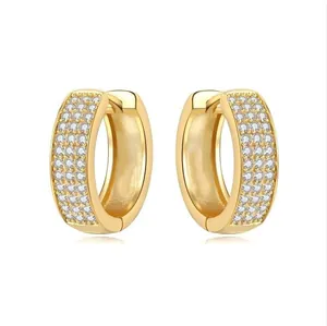 Detailed macro view of 18K gold plated hoop earrings with three-row pavé cubic zirconia