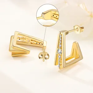 Macro detail view of 18K gold plated V-shaped hoop earrings with clear zircon stones