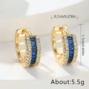 Elegant gold-tone huggie hoop earrings with blue and clear zircon stones