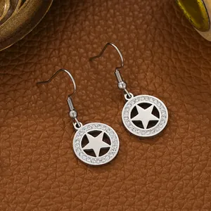 Close-up of titanium steel star earrings with pavé-set clear rhinestones on leather