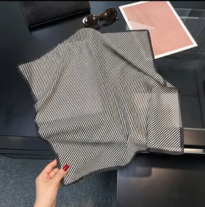 Detailed view of the breathable black and white striped silk-cotton square scarf