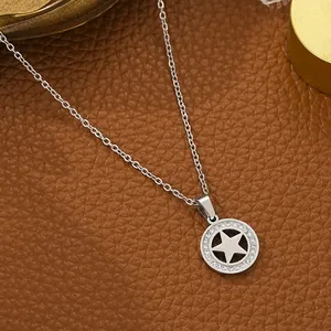 Detail of silver stainless steel star pendant necklace with sparkling crystal inlay.