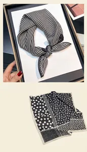 Detailed view of the elegant striped and polka dot patterns of a premium silk square scarf
