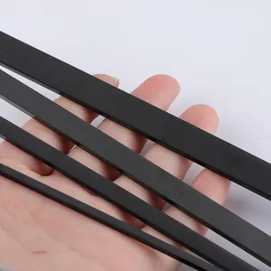 Detail shot of various black polished stainless steel strips for DIY bracelet making