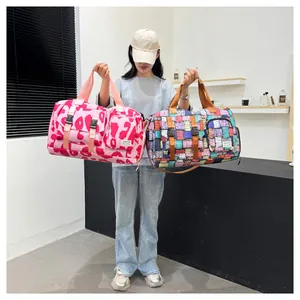 Large capacity gym bag with colorful patterns and pink leopard print held by a model