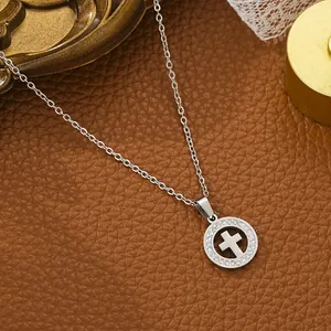 Detailed view of silver stainless steel necklace with sparkling rhinestone cross pendant