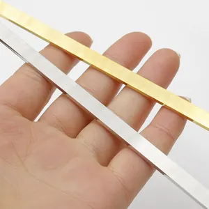 Detail view of polished gold and silver stainless steel strips for DIY bracelet making