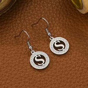 Close-up view of silver stainless steel S-shaped hook earrings with clear rhinestones