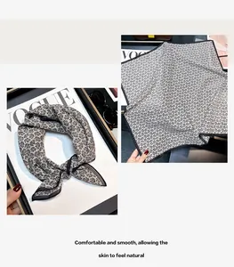 Detail view of lightweight silk cotton blend square scarf with black and white floral print