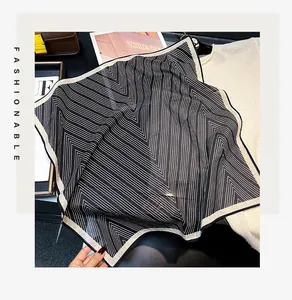 Detailed view of lightweight 55cm silk cotton blend square scarf with geometric stripes
