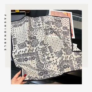 Detail of elegant 55cm paisley print square scarf in breathable silk cotton blend