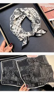 Detail view showing the elegant paisley pattern on a 55cm silk-cotton square scarf.