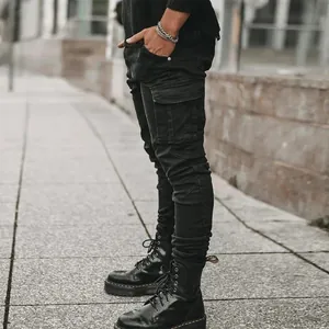 Detailed close-up of men's black slim-fit cargo skinny jeans with side pockets.