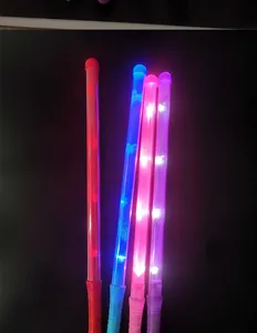 Detailed view of colorful LED glow sticks illuminated against a dark background