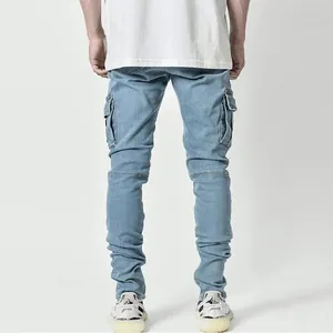 Detailed back view of men's blue slim fit cargo jeans with multiple side pockets
