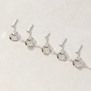 Close-up of five silver metallic magnetic nail art display stands in chess piece style