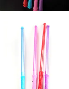 Detail of four colorful LED glow sticks in blue pink red and purple for concerts