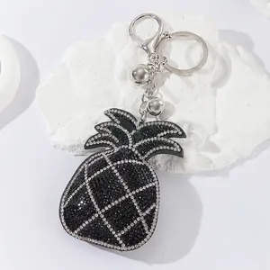Macro view of rhinestone pineapple keychain with sparkling crystals and silver bells