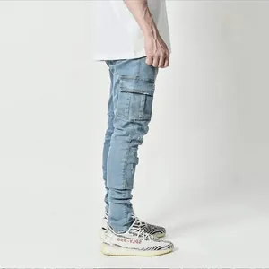 Detailed side view of light blue men's skinny cargo jeans featuring functional side pockets