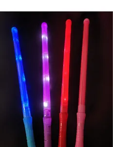 Close-up of four colorful LED glow sticks emitting vibrant blue, purple and red light.