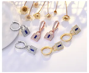 Detailed view of micro-pave lock charm hoop earrings in gold, silver, and rose gold finish