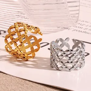 Detail of gold and silver hollow-out lattice pattern titanium steel open rings