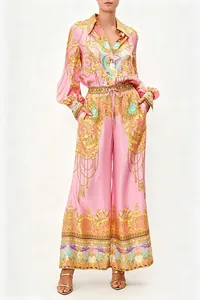 Detailed view of women's pink two-piece set with ornate golden baroque pattern print