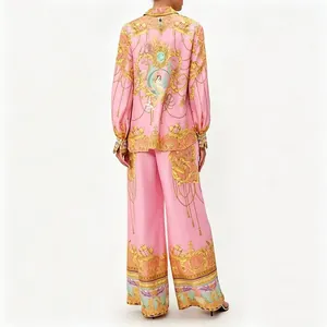 Pink Baroque print two-piece set featuring long-sleeve shirt and wide-leg trousers.
