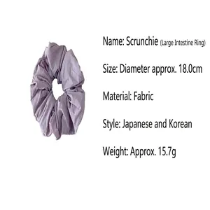 Detailed close-up of a purple fabric scrunchie featuring product size and weight info