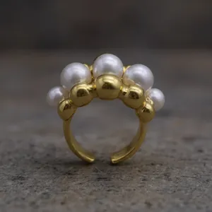 Elegant gold plated stainless steel open ring featuring a row of lustrous white pearls
