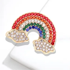 Vibrant rainbow cloud brooch with sparkling multi-color rhinestones and gold finish.