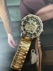 Detail view of a men's luxury skeleton mechanical watch with a diamond-set gold bezel.