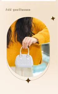Close-up view of a stylish white mini PVC jelly shell handbag being held by a model
