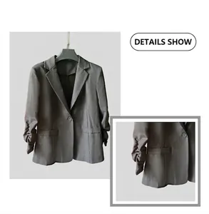 Detailed view of a women's slim blazer with ruched sleeves and a single button closure