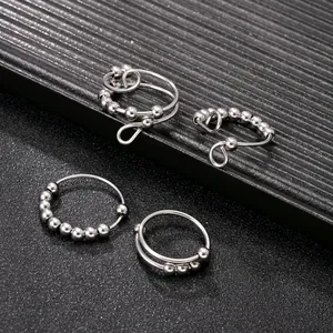 Four-piece set of stainless steel fidget rings with rotatable beads and sleek finish