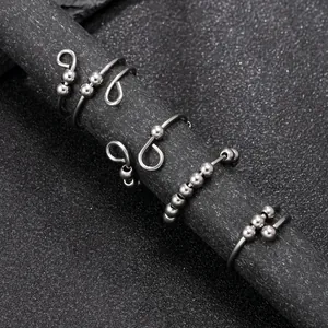 Four-piece stainless steel spinner ring set with rotating beads and industrial design
