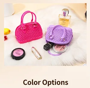 Pink and purple mini PVC jelly shell handbags displayed on white fur with cosmetics