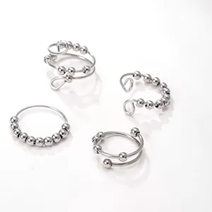 Set of four stainless steel fidget rings featuring rotatable beads in silver finish.
