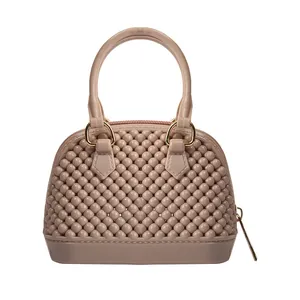 Elegant nude beige PVC jelly shell bag featuring unique 3D beaded texture and gold tone hardware.