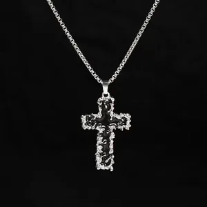 Detailed view of niche cross necklace with molten silver texture and black glossy center.