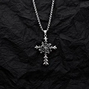 Close-up of gothic silver cross necklace featuring an intricate rose flower design in center.
