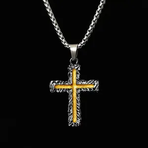Detailed macro view of a vintage two-tone cross pendant necklace with a box chain