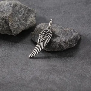 Detailed view of stainless steel angel wing pendant with antique silver finish.