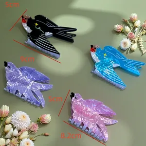Detailed view of four colorful bird-shaped hair claws featuring size measurements