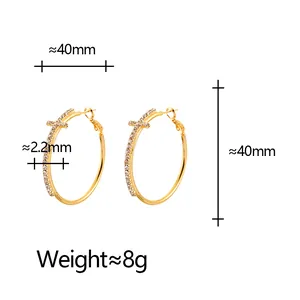 Detailed view of gold cross hoop earrings with 40mm diameter and weight specifications