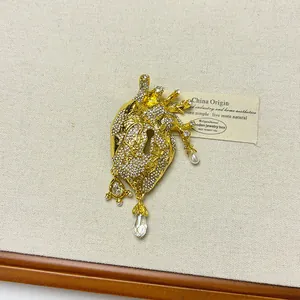 Elegant vintage gold anatomical heart brooch with crystals and dangling pearl charms