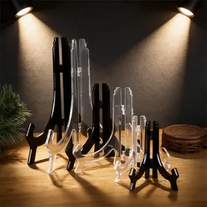 A collection of black and transparent plastic easel stands in various sizes for display