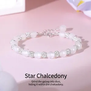 Close-up of starlight chalcedony bead bracelet with sparkling crystal pave accents.