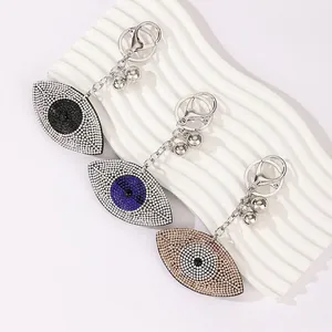 Sparkling rhinestone evil eye keychains in blue, black and gold for bag decoration